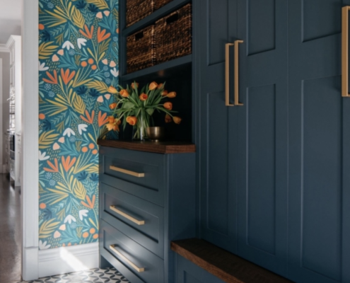 Blue cabinets with flowered wallpaper