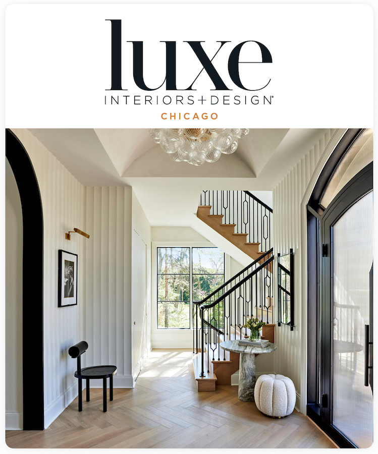A modern entryway with a black and white color scheme, featuring a curved staircase, a marble console table, and a large window.